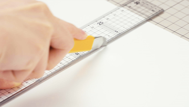 Use the spine of a thick ruler